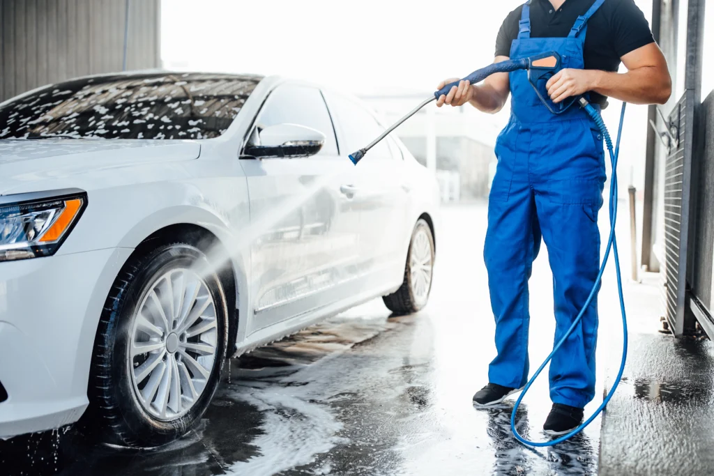 A man wash car using car washer